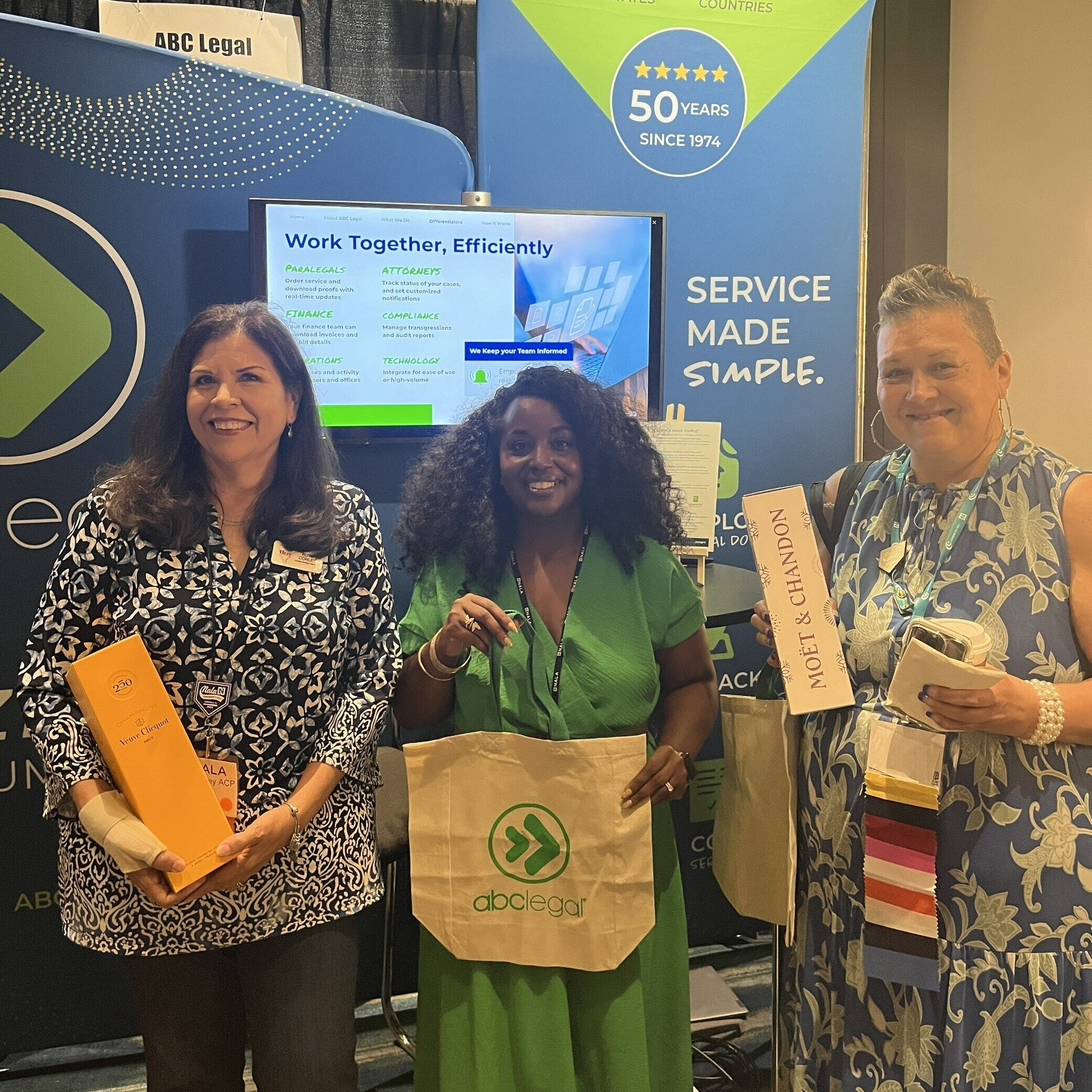 ABC Legal representatives networking with attendees at the NALA Annual Conference booth.