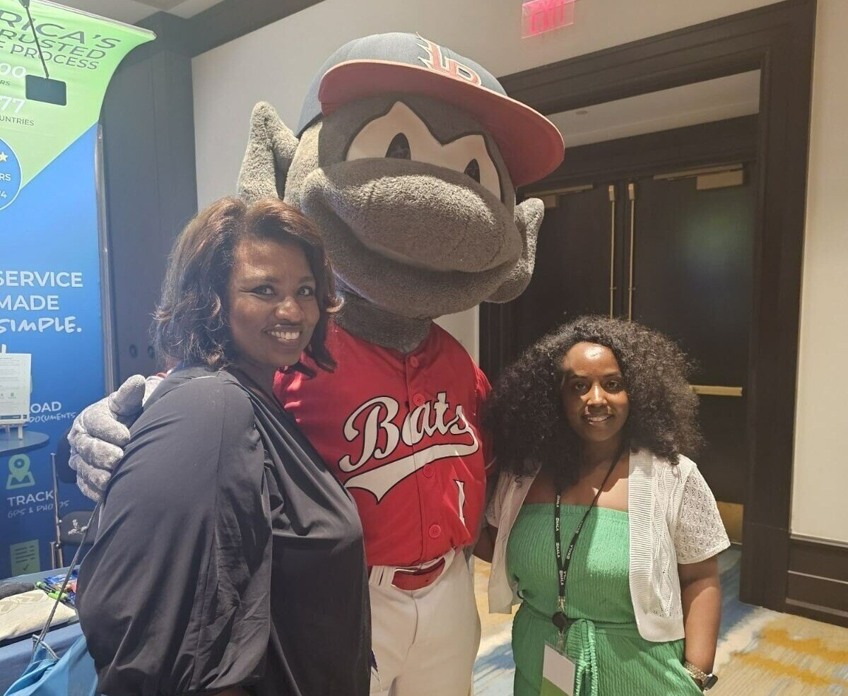 ABC Legal team members posing with the Louisville Bats baseball mascot at NALA.