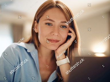 stock-photo-smiling-businesswoman-working-on-a-computer-at-home-2673917521 1