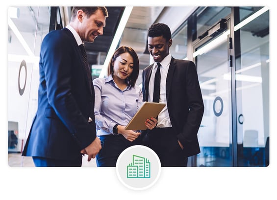 business workers looking at a tablet in an office