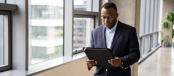 Legal professional walking and reviewing his case