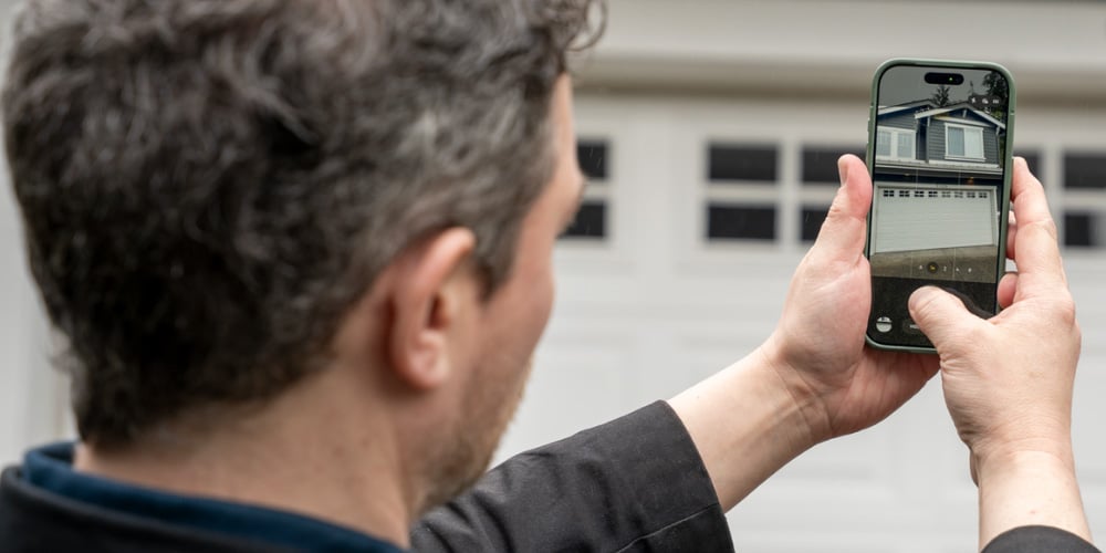 A process server reviewing the photo evidence captured at the door